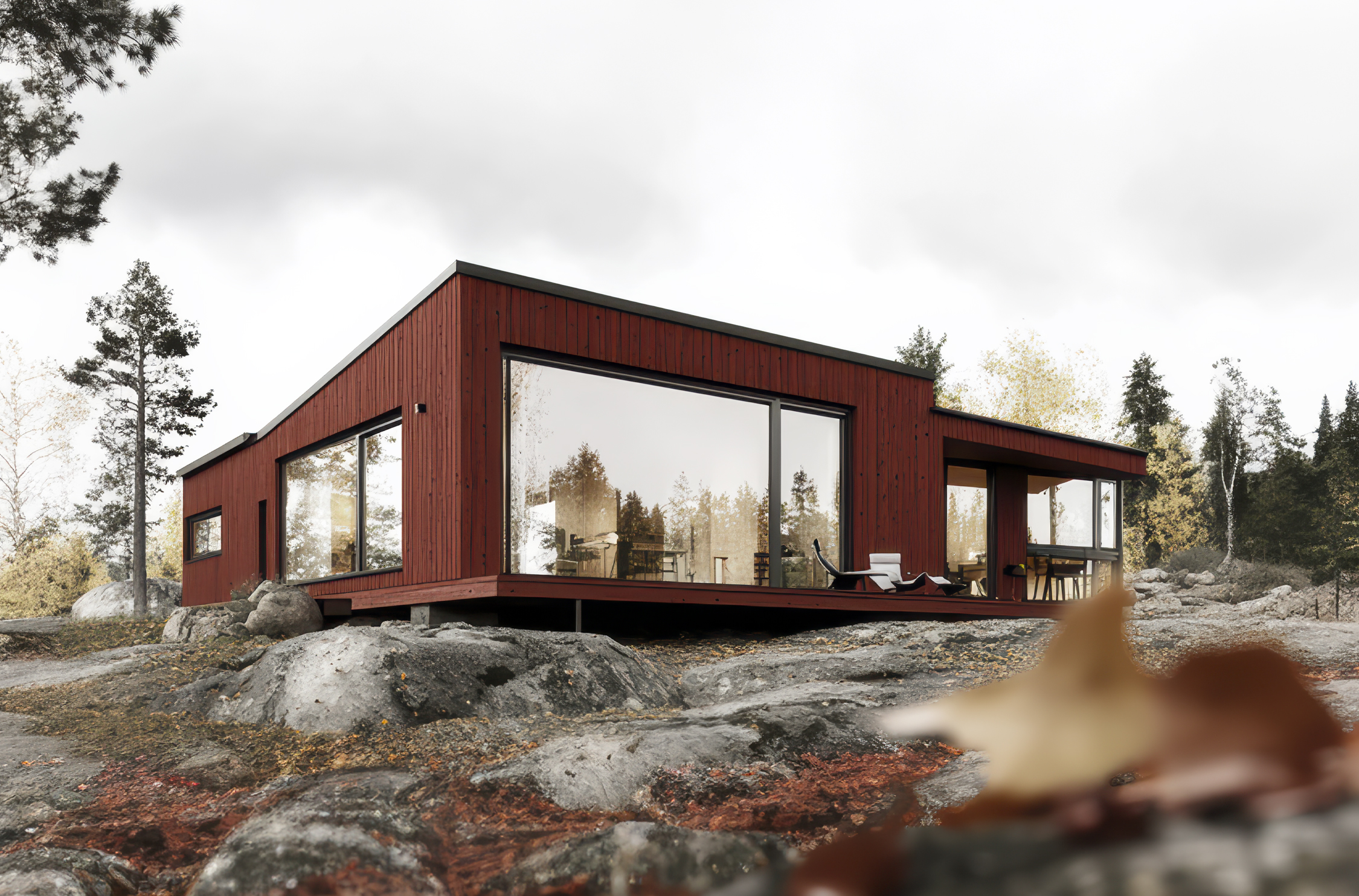 Kampanjbild för Caparols träskydd Modernt trähus med rödmålad träfasad i naturmiljö, kampanjbild för Caparols träskyddssystem.